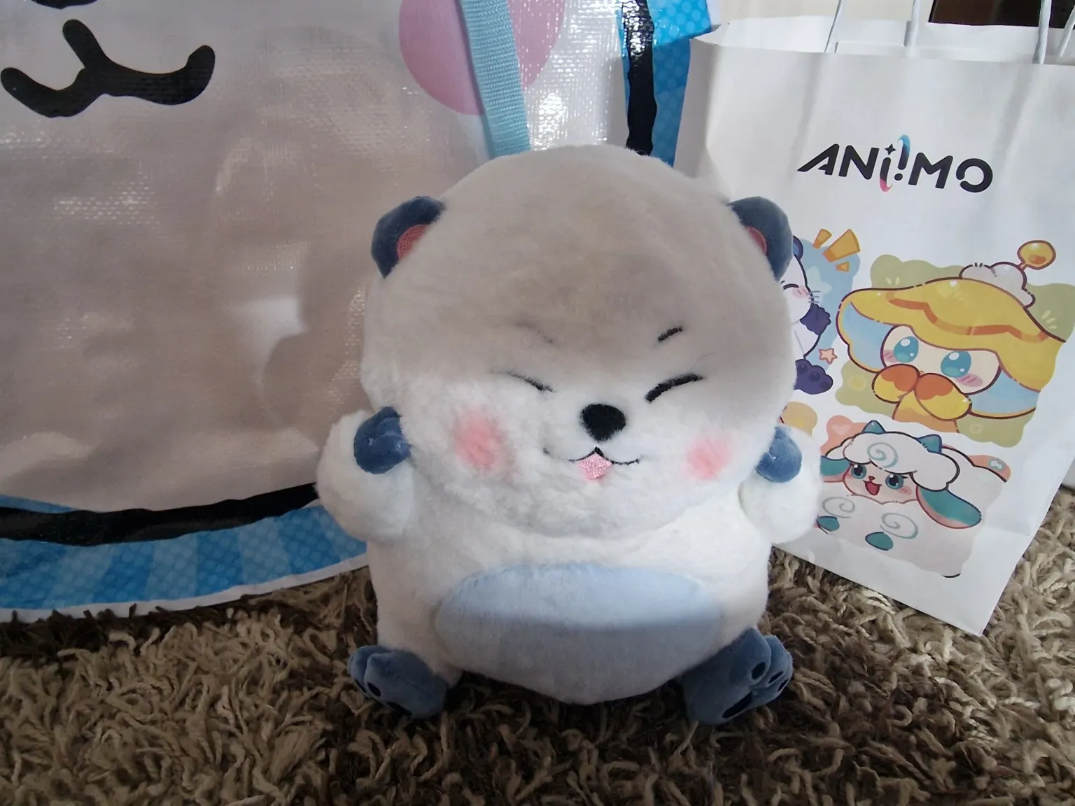 An Aniimo plushie in front of the goodie bags after visiting gamescom 2026.